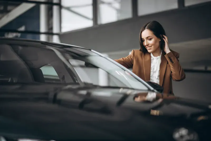 Passenger beside a sedan while arranging a chauffeur-driven journey
