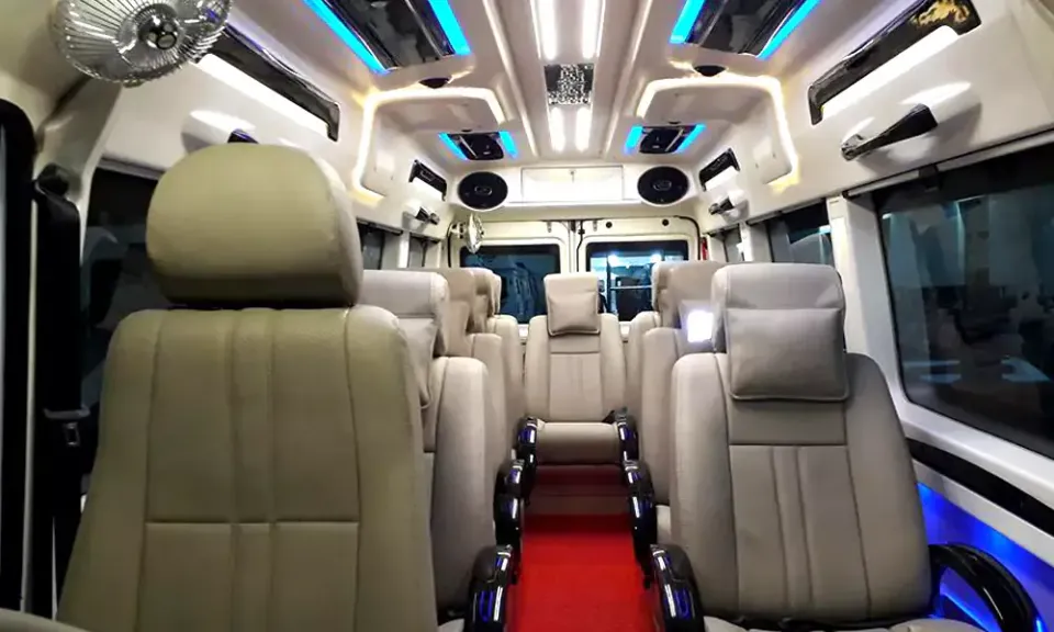 Passenger seats and aisle inside a Tempo Traveller